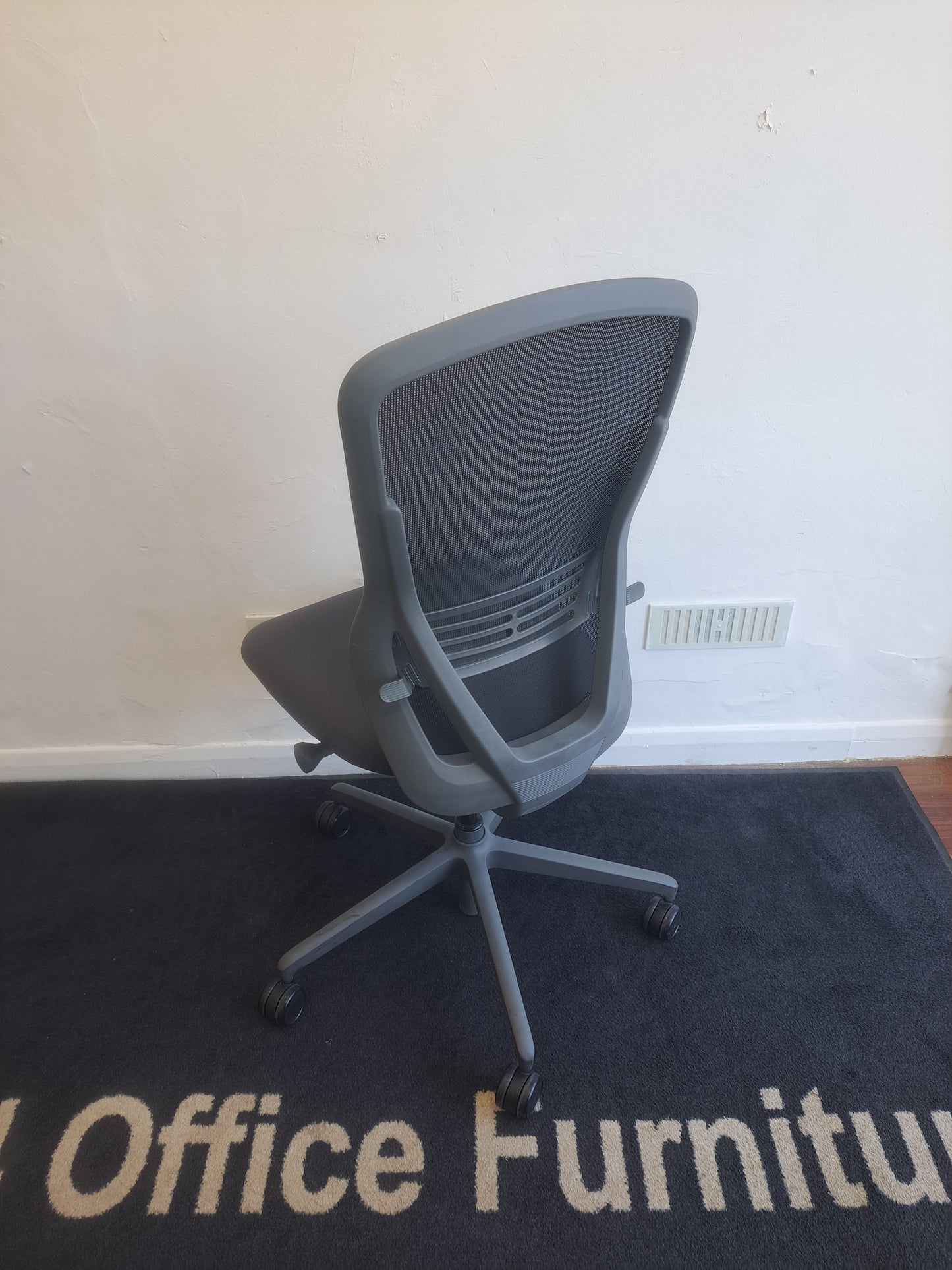 Grey operator chair without arms